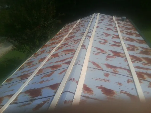 Rusted metal roof panels with new wood purlins before replacement — Storm Damage Roof Repair in Argos by Roofing Brothers