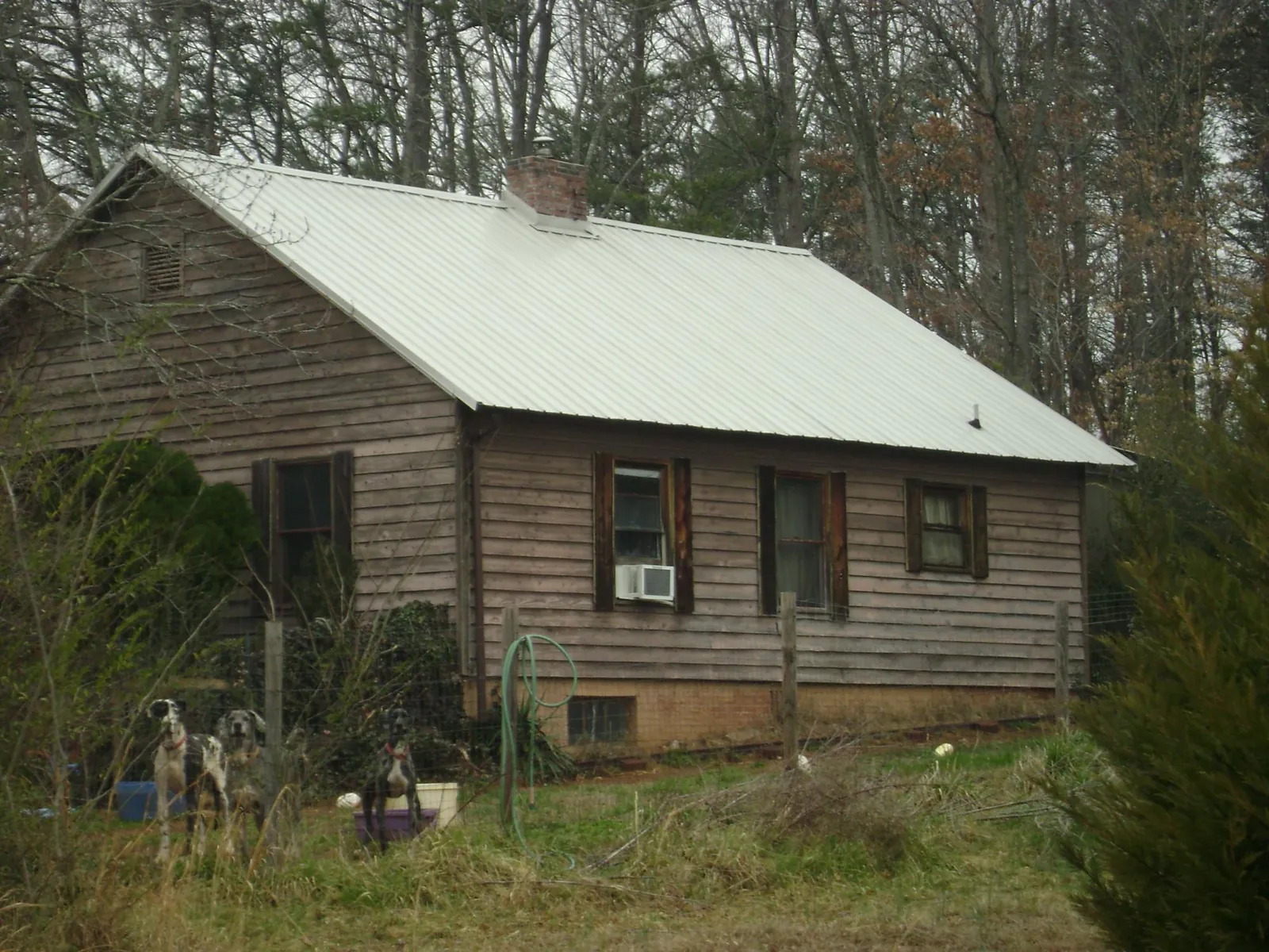 White metal roof on an old wood sided farmhouse, from a Metal Roof Installation job in Argos